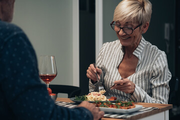 Cheerful couple have romantic dinner at home stock photo