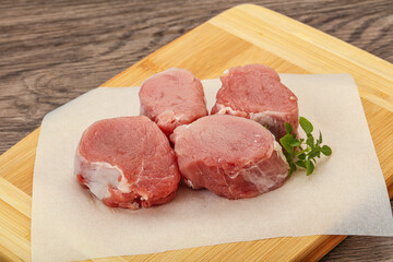 Raw pork medallion served rosemary