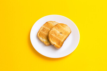 Breakfast toast on a plate on a yellow background