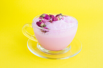 Closeup on rose moon milk in glass cup on the yellow background