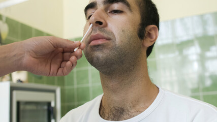 Man testing with swab for coronavirus in laboratory