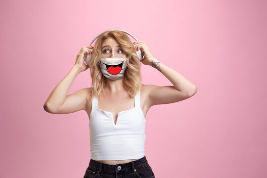 Laughting. Portrait Of Young Girl With Emotion On Her Protective Face Mask On Studio Background. Beautiful Female Model, Funny Expression. Human Emotions, Facial Expression, Sales, Ad, Healthcare