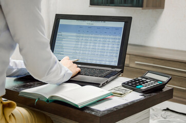finance girl working online. online training. the girl looks at the financial statement