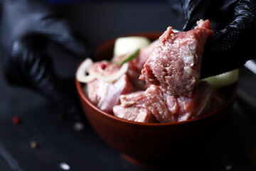 Selective focus. Macro. Chunks of raw meat with onions. Cooking kebabs.
