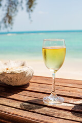 wooden table at a beach bar with a drink in front of turquoise water Ko Samui, thailand