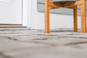 low angle view of a stamped concrete patio with a potted plant on a plant stand and there is ample copy space for text.