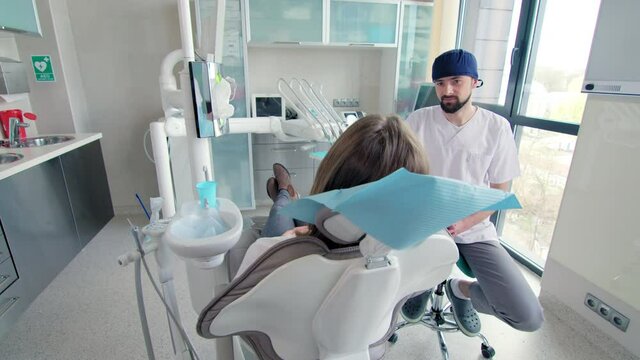 Dentist talking with patient in dentists office
