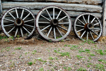Fototapeta na wymiar Abandoned wagon wheels in a ghost town, Old Trail Town, Cody, Wyoming, USA