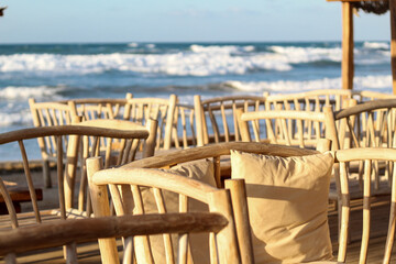 Wooden chairs on the beach. Crete, Greece 2019.