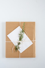 Brown Paper Package with Twine and Rosemary Sprig