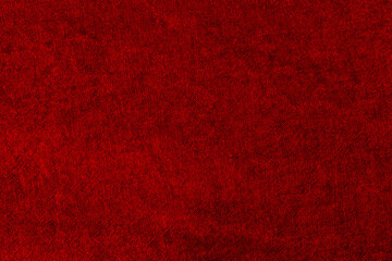 Dark red background with checkered pattern, closeup. Structure of the wine fabric with natural texture. Cloth backdrop.