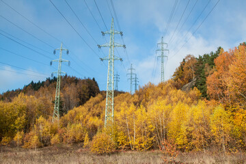 high voltage pylon, in a hill in autumn, golden leaves of stoma