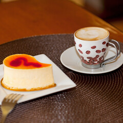 Close-up of a cup of coffee with a mousse cake
