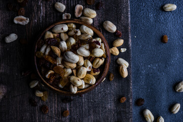Fototapeta na wymiar Healthy nuts on dark background