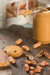 Close-up of peanut butter with peanuts and cookies