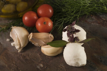 Close-up of bocconcini cheese with fresh herbs and vegetables