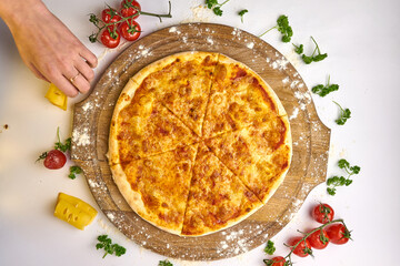 Italian pizza Margarita with mozzarella and tomato sauce on wooden table