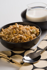 Close-up of breakfast cereal with a cup of milk