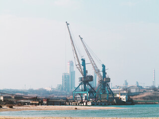 Harbor crane. Two old rusty cranes in an industrial port in the fog.