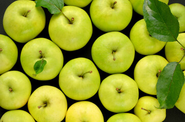 green apples close up on black background flat lay
