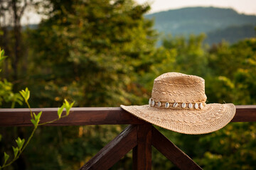 straw hat made of eco-friendly material, lying on the background of nature and mountains