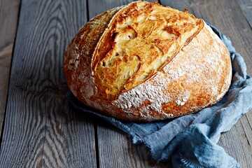 Fresh homemade bread on a gray( blue) background. Crisp French bread. Bread at leaven. Unleavened bread
