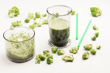 Blender bowls with green vegetable smoothies.