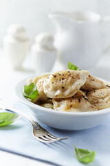 Dumplings with potato and cottage cheese stuffing (pierogi). Traditional Polish Christmas Dinner. Bright background.	