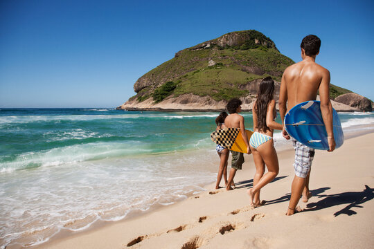Friends walking together on tropical beach