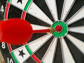Dart arrow hit target at bullseye