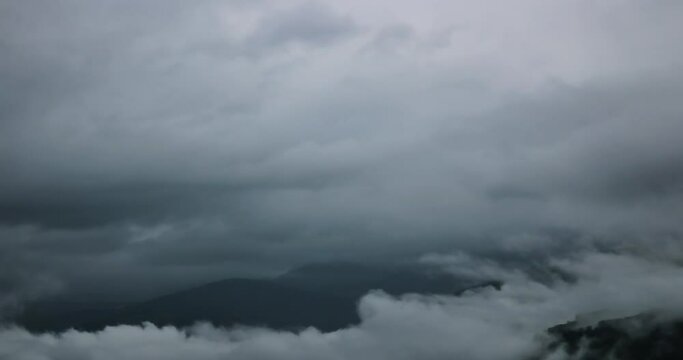 4k Morning Time lapse for big clouds increasing gradually in a stormy day and passing over Chamrousse Mountain till it covers the whole screen at Grenoble Alps in France.