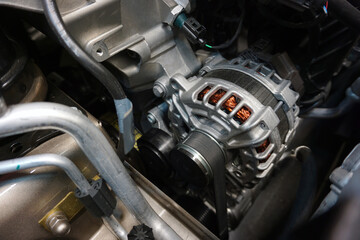 Fototapeta na wymiar Generator (alternator) installed in the engine of a modern car.