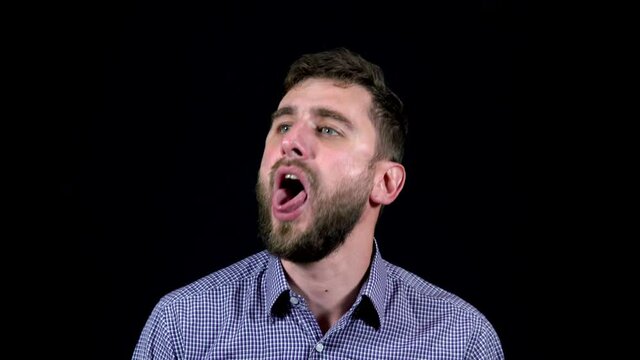 Man with sore throat coughs badly on black background 4k