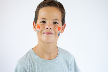 Portrait of young handsome boy, his face painted with paints