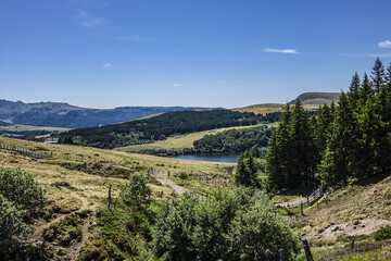 Highland landscapes in Volcans d'Auvergne regional Natural Park with Lac du Guery - highest lake in Auvergne at 1250m altitude. Massif Central, Auvergne-Rhone-Alpes administrative region, France.