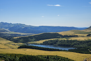 Highland landscapes in Volcans d'Auvergne regional Natural Park with Lac du Guery - highest lake in Auvergne at 1250m altitude. Massif Central, Auvergne-Rhone-Alpes administrative region, France.