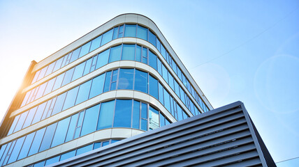 Office building, details of blue glass wall and sun reflections.