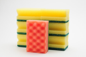 Sponge for washing dishes and plumbing on a white background