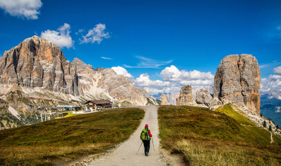 Fototapeta na wymiar Hiker near Cinque Torri. Sport and active life concept. Amazing view of Dolomites Alps, Italy, Europe. Travel in nature. Artistic picture. Beauty world.