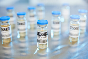Group of Covid-19 coronavirus vaccine vials in laboratory on stainless steel table