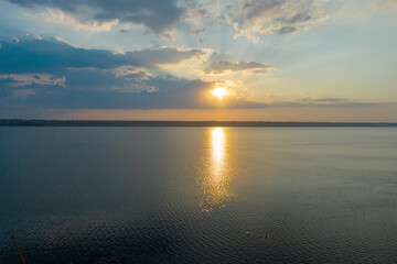 Fototapeta premium Beautiful twilight silhouette sunset on the Kuyalnik estuary near Odessa. Sunset over the lake. Evening sky with colorful cloud on twilight, Dusk