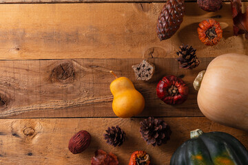 Autumn banner with yellow pear, bumps, pumpkins, leaves, dried pepper isolated on wooden...