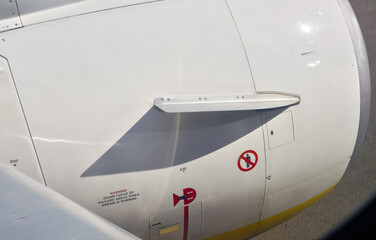 Warning and information signs on commercial airplane jet engine covering
