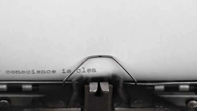 typing a quote my conscience is clear on a vintage typewriter close-up