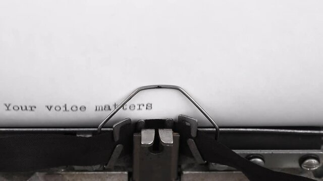 typing a message your voice matters on a vintage typewriter close-up