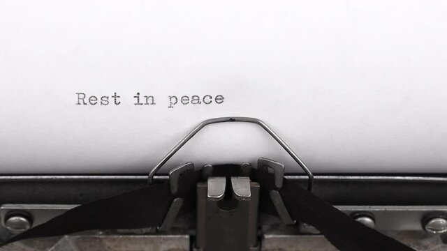 typing a message rest in peace on a vintage typewriter close-up