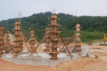 KUALA LUMPUR, MALAYSIA -SEPTEMBER 19, 2020: Column timber form work and reinforcement bar at the construction site. Installed by construction workers. The structure supported by temporary wood support