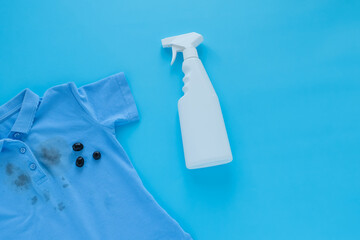 dirty black olive stains on clothes and stain removers. Stain cleaners.top view. Isolated on a blue background