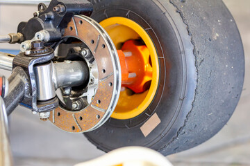 hydraulic caliper disc brake unit assembly on front wheel spindle axle bracket of mini racing car...