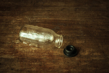 Medical bottle made of glass on an old wooden background